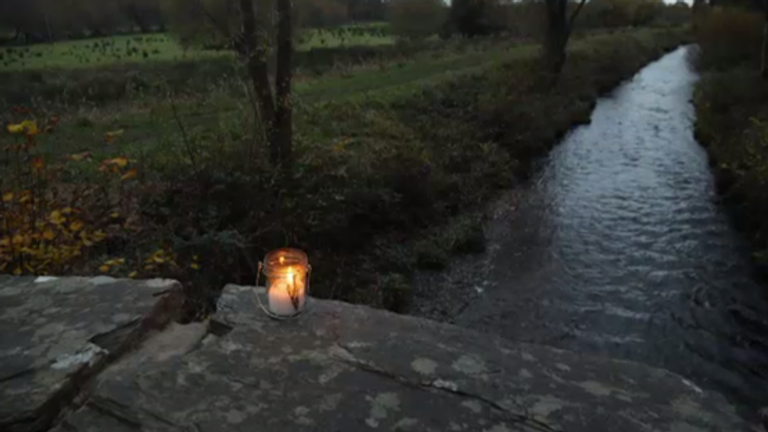 A solitary candle left at the scene in Garreg, Gwynedd, in memory of four teenagers who were found dead