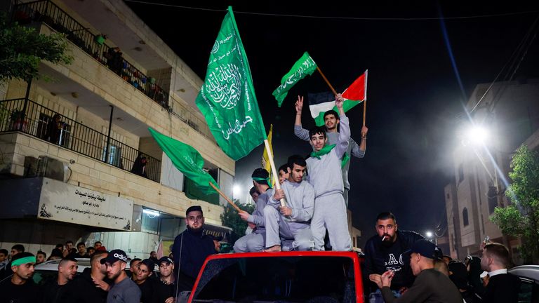 Released Palestinian prisoners wave flags atop a car as they leave the Israeli military prison, Ofer, after hostages-prisoners swap deal between Hamas and Israel near Ramallah in the Israeli-occupied West Bank November 24, 2023. REUTERS/Ammar Awad