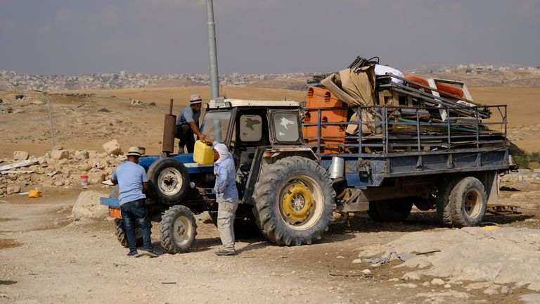 Men loading a tractor trailer in Zanota 