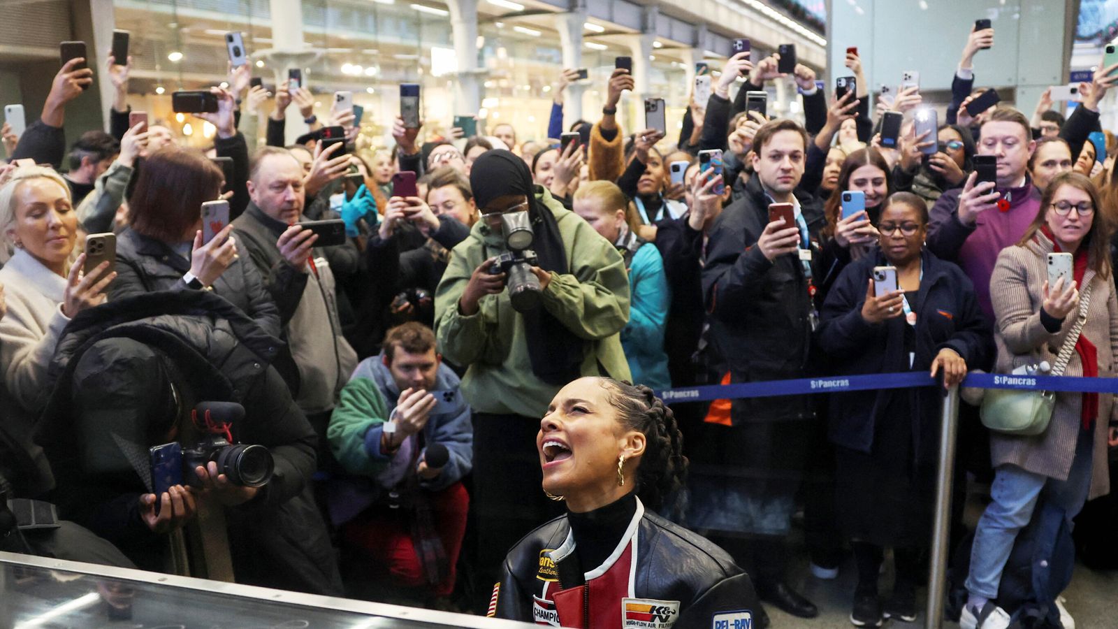 Alicia Keys plays surprise set on piano at St Pancras station in London