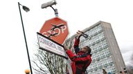 A person removes the Banksy artwork
