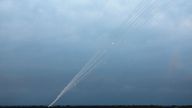 Smoke trails are seen as a salvo of rockets are launched from the Gaza Strip into Israel as seen from southern Israel 