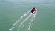 A group of migrants on an inflatable dinghy leave the coast of northern France to cross the English Channel, in Wimereux near Calais, France, December 16, 2021. Picture taken with a drone.  REUTERS/Pascal Rossignol