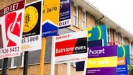 Advertising hoardings outside real estate housing development in London. Large group of Estate agents boards in United Kingdom.