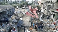 Palestinians gather at the site of Israeli strikes on houses  at the Maghazi camp in the central Gaza