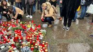 People lay tributes outside Charles University after a mass shooting