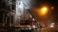 Firefighters tackle a fire after Russia&#39;s missile attack in Kharkiv on New Year&#39;s Eve. Pic: Ukrainian Emergency Service/AP