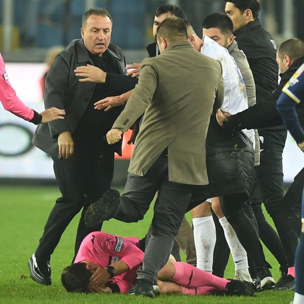 Faruk Koca (left) reacts as Halil Umut Meler lies on the ground