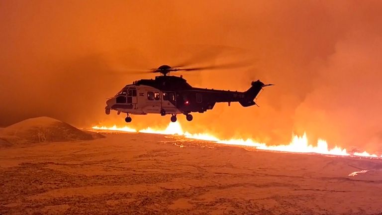 This image made from video provided by the Icelandic Coast Guard shows its helicopter flying near magma running on a hill near Grindavik on Iceland's Reykjanes Peninsula sometime around late Monday, Dec. 18, or early Tuesday, Dec. 19, 2023. A volcanic eruption started Monday night on Iceland's Reykjanes Peninsula, turning the AGټ߹ orange and prompting the country&#8217;s civil defense to be on high alert. (Icelandic coast guard via AP)