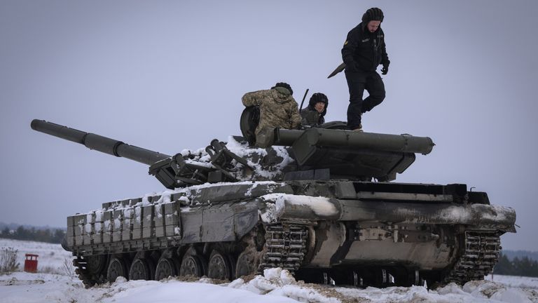 FILE - Ukrainian soldiers practice on a tank during military training, in Ukraine, Wednesday, Dec. 6, 2023. A gloomy mood hangs over Ukraine’s soldiers nearly two years after Russia invaded their country. Ukrainian soldiers remain fiercely determined to win, despite a disappointing counteroffensive this summer and signs of wavering financial support from allies. (AP Photo/Efrem Lukatsky, File)