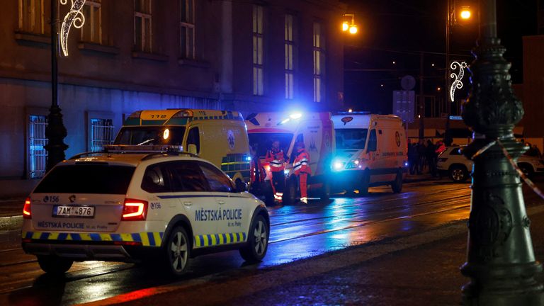 A police car drives past ambulances parked near the area of the shooting at one of the buildings of Charles University in Prague, Czech Republic, December 21, 2023. REUTERS/David W Cerny
