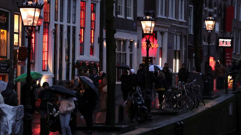 Many tourists visit Amsterdam to enjoy the nightlife in the red light district