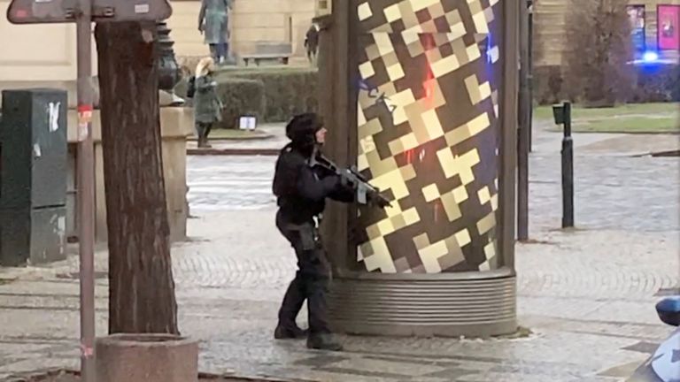 An armed police officer takes position near the area of a shooting at one of the buildings of Charles University, in Prague, Czech Republic, December 21, 2023, as seen in this screen grab taken from a social media video. Ivo Havranek/via REUTERS THIS IMAGE HAS BEEN SUPPLIED BY A THIRD PARTY. MANDATORY CREDIT. NO RESALES. NO ARCHIVES.
