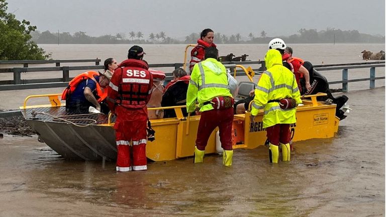 Emergency workers evacuating people from flood waters in Queensland