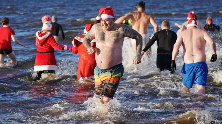 Santa costumes at the Ayrshire Cancer Support Boxing Day Dip at Ayr Beach 