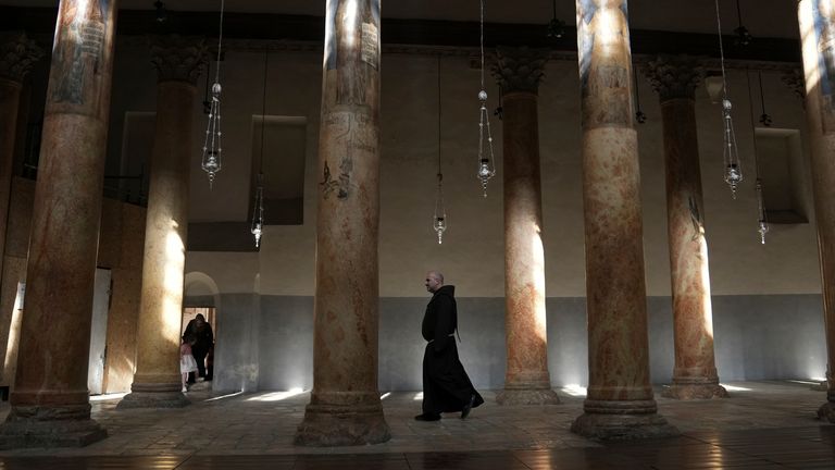 A priest walks at the Church of the Nativity in the West Bank town of Bethlehem, Saturday, Dec. 16, 2023. Pic: AP