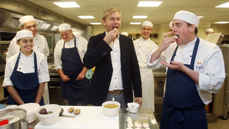 Bill Granger tasting a pavlova in the kitchens at Buckingham Palace