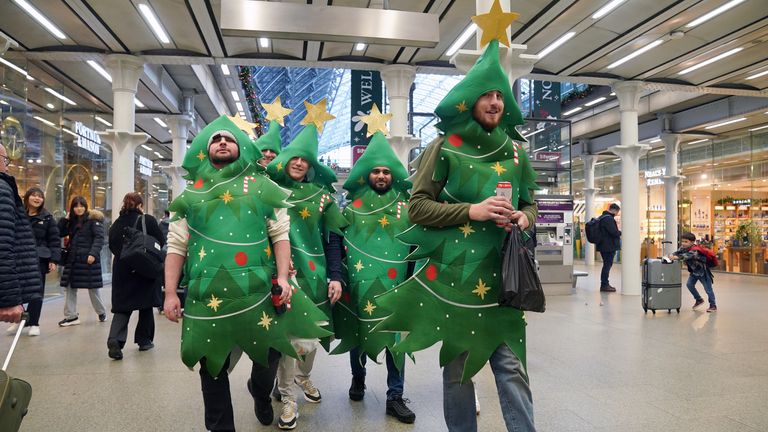  Passengers dressed as Christmas trees at St Pancras International station, London, as Christmas getaway chaos is expected to continue as the backlog from the suspension of cross-Channel rail services begins to clear and the weather remains unsettled. An unexpected strike by Eurotunnel French site staff on Thursday led to widespread disruption, before it came to end in the evening, with trade union representatives reaching an agreement with management. Picture date: Friday December 22, 2023.