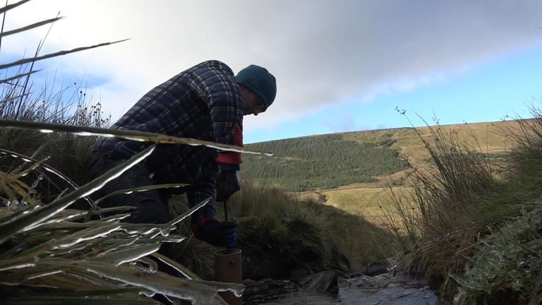 Professor Dominick Spracklen installs pressure gauges into a stream