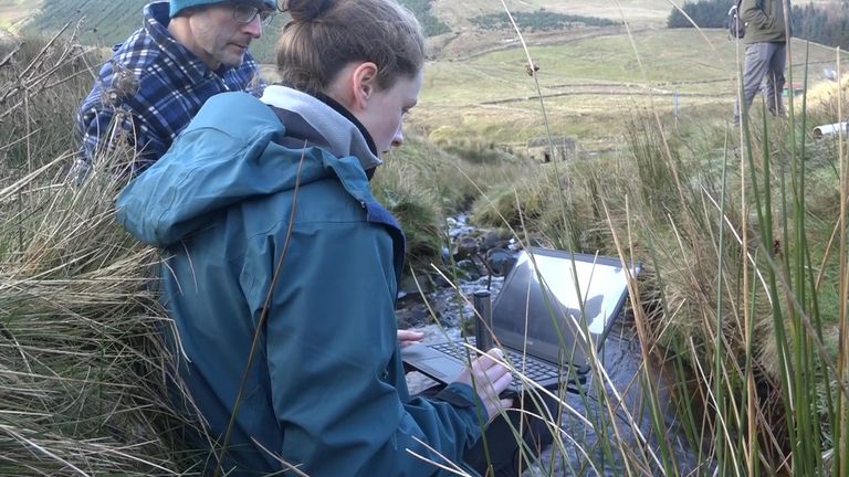 Robyn Wrigley and Professor Dominick Spracklen monitor the pressure gauges in a stream