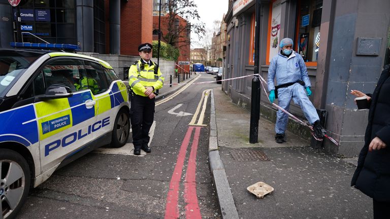 A Metropolitan Police officer near to a property in Hackney where a man died from stab wounds