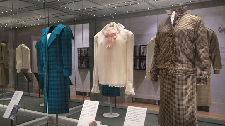 (From the left) A green and black tartan wool day-suit worn by the Princess of Wales on a royal visit to Italy in 1985, a pale pink chiffon blouse worn for Diana&#39;s first official portrait in 1981 and brown tweed wool day suit worn on her honeymoon in Balmoral in 1981 at the preview of Diana: Her Fashion Story exhibition at Kensington Palace in London.
