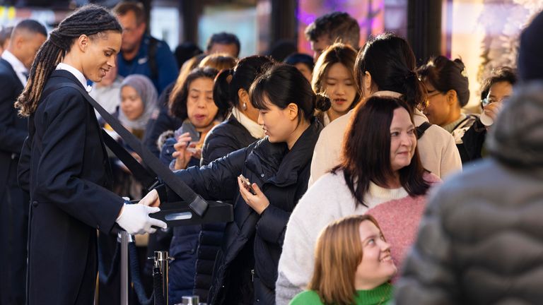 Harrods staff offered refreshments to customers queueing outside the Knightsbridge store