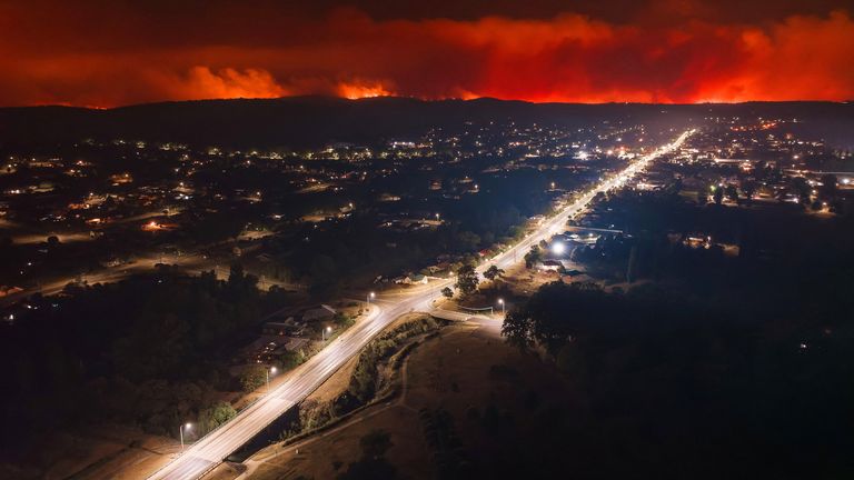 Fire is seen in the distance from the Tenterfield CBD, in Tenterfield, Australia, October 31, 2023