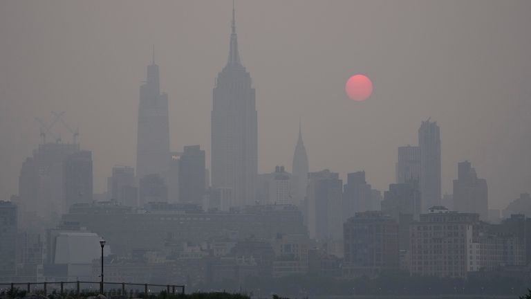 The sun rises over a hazy New York City skyline as seen from Jersey City, N.J., Wednesday, June 7, 2023. Intense Canadian wildfires are blanketing the northeastern U.S. in a dystopian haze, turning the air acrid, the sky yellowish gray and prompting warnings for vulnerable populations to stay inside. (AP Photo/Seth Wenig)