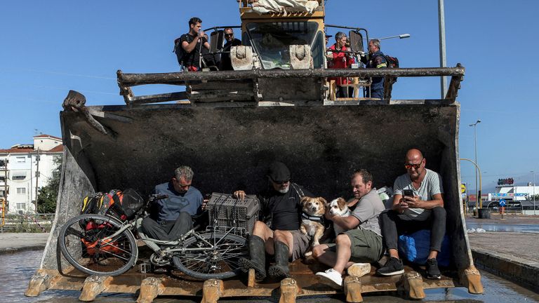 Locals are evacuated on an excavator from a flooded area in the aftermath of Storm Daniel in Larissa, Greece, September 10, 2023. REUTERS/Elias Marcou SEARCH "GLOBAL POY 2023" FOR THIS STORY. SEARCH "REUTERS POY" FOR ALL BEST OF 2023 PACKAGES. TPX IMAGES OF THE DAY