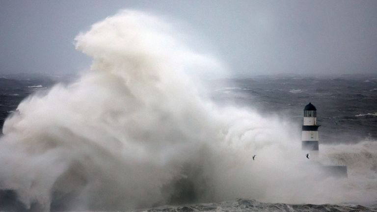 Waves crash against Seaham lighthouse during Storm Babet in Seaham, Britain, October 20, 2023. REUTERS/Lee Smith