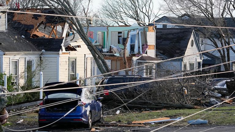 Storm damaged homes are seen along Nesbitt Lane, Sunday, Dec. 10, 2023 in Nashville, Tenn. Central Tennessee residents and emergency workers are continuing the cleanup from severe storms and tornadoes that hit the area. (AP Photo/George Walker IV)