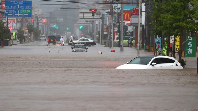 A photo shows a flooded road in Akita City, Akita Prefecture on July 15, 2023. Due to the influence of the seasonal rain front, Akita Prefecture experienced record heavy rain on the 15th.( The Yomiuri Shimbun via AP Images )