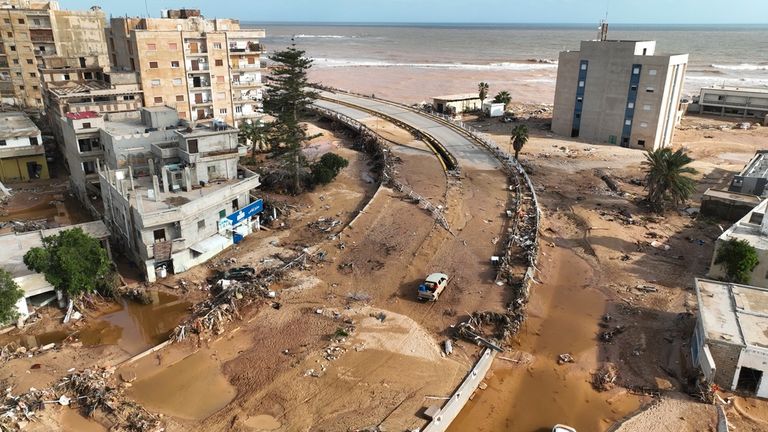 FILE - A damaged road is visible following storm Daniel in Derna, Libya, Sept. 12, 2023. This year...s COP28 in Dubai is likely to see more discussion about compensation for developing nations harmed by climate change. (AP Photo/Jamal Alkomaty)