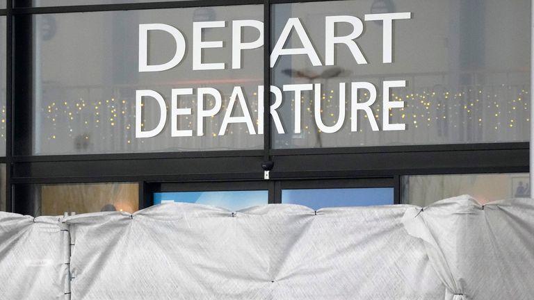 Canvas prevent to see inside the Vatry airport, Saturday, Dec. 23, 2023 in Vatry, eastern France. About 300 Indian citizens heading to Central America were sequestered in a French airport for a third day Saturday because of an investigation into suspected human trafficking, authorities said. The 15 crew members of the Legend Airlines charter flight en route from United Arab Emirates to Nicaragua were questioned and released, according to a lawyer for the small Romania-based airline. (AP Photo/Christophe Ena)