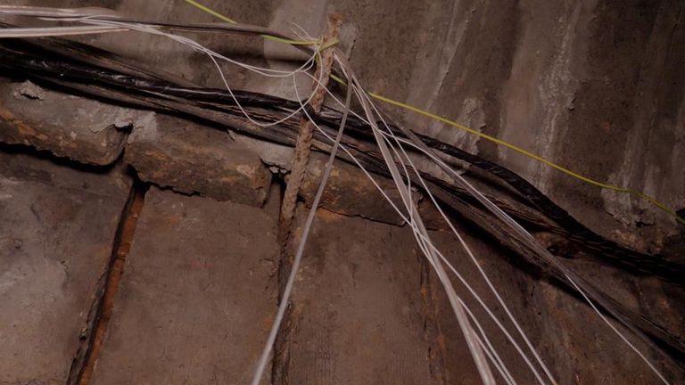 Cables dangled from the roof of the tunnel