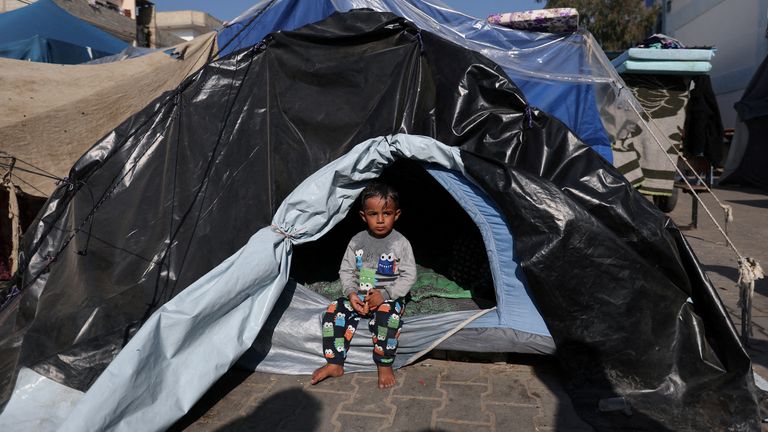 A child sits in a tent as Palestinians, who fled their houses amid Israeli strikes, shelter at a United Nations-run school, amid the ongoing conflict between Israel and the Palestinian Islamist group Hamas, in Khan Younis, in the southern Gaza Strip, December 4, 2023. REUTERS/Ibraheem Abu Mustafa  TPX IMAGES OF THE DAY