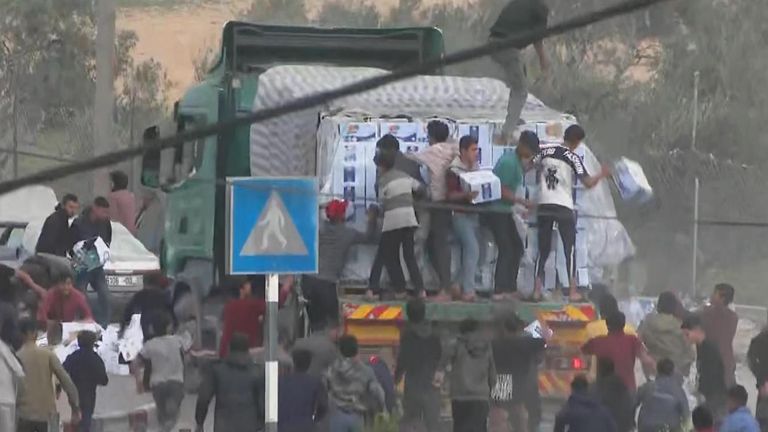 Chaotic scenes in Rafah as people throw aid from moving trucks