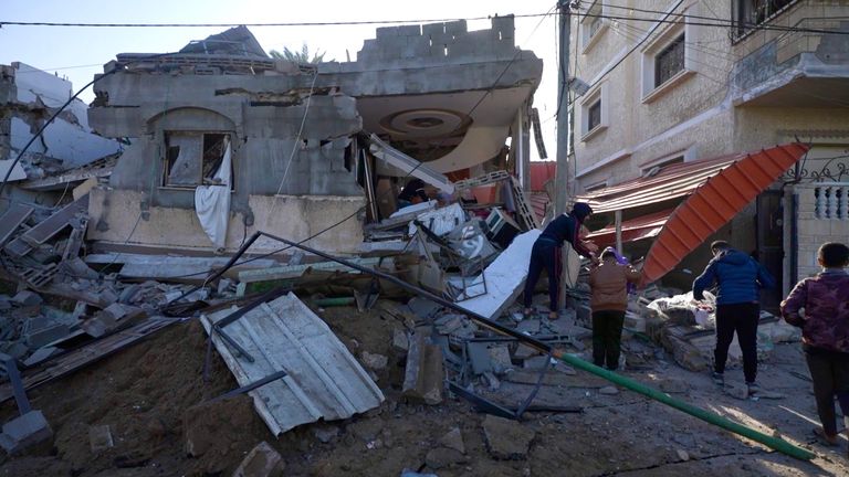 Residents inspect the ruins of a destroyed house in Gaza 
