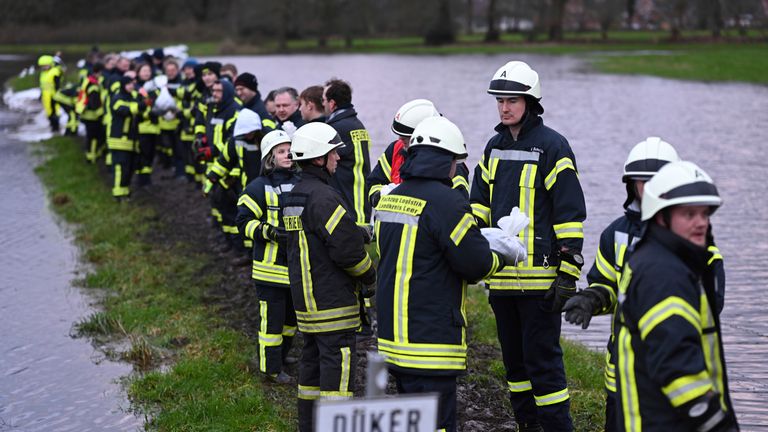 Firefighters try to secure the village with sandbags after floodwater from the Burlage-Langholter Tief, a tributary of the Leda, overflowed or softened the dykes
Pic:DPA/AP