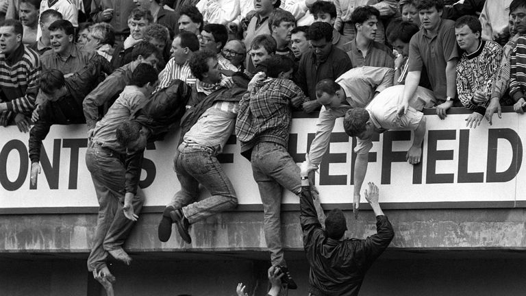 File photo dated 15/4/1989 of Liverpool supporters climbing to safety during the Liverpool v Nottingham Forest FA Cup semi-final football match at Hillsborough which led to the deaths of 97 people. The Government is due to respond to recommendations made by Bishop James Jones in his report, The Patronising Disposition Of Unaccountable Power, which found failings in the way the bereaved families of the Hillsborough disaster were treated by those in authority. Issue date: Wednesday December 6, 202