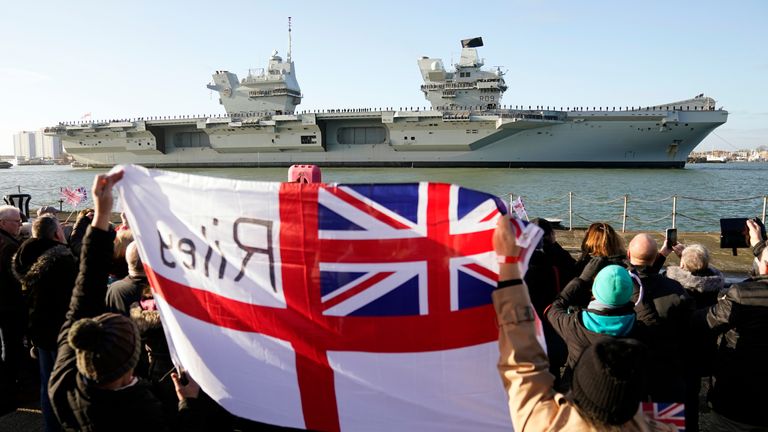 Friends and family of members of crew welcome back the Royal Navy aircraft carrier HMS Prince of Wales as it returns to Portsmouth Naval Base following a three-month deployment to the Eastern Seaboard of the United States, where the Prince of Wales has been undergoing trials and operating with aircraft and drones. Picture date: Monday December 11, 2023.
