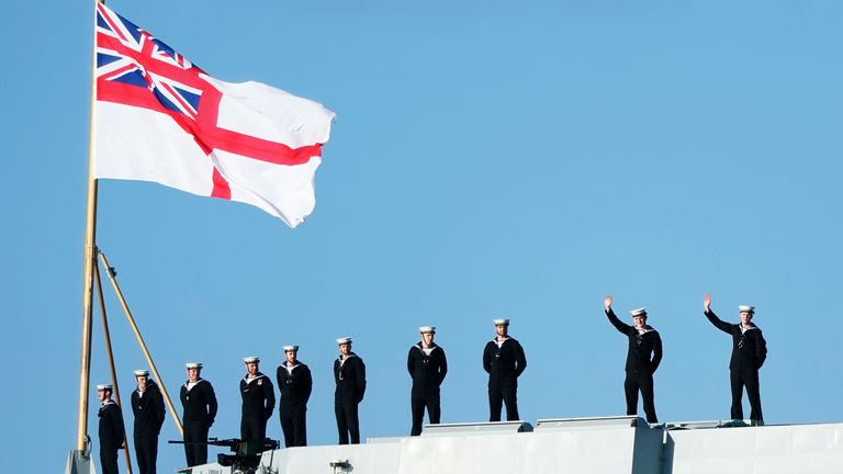 Sailors wave from the stern of the Royal Navy aircraft carrier HMS Prince of Wales as it returns to Portsmouth Naval Base following a three-month deployment to the Eastern Seaboard of the United States, where the Prince of Wales has been undergoing trials and operating with aircraft and drones. Picture date: Monday December 11, 2023. PA Photo. See PA story DEFENCE Carrier. Photo credit should read: Andrew Matthews/PA Wire