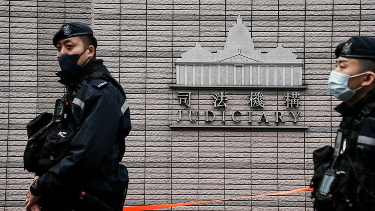Police officers stand guard outside the West Kowloon Magistrates&#39; Courts during the national security trial of media mogul Jimmy Lai, founder of Apple Daily, in Hong Kong, China December 18, 2023. REUTERS/Lam Yik
