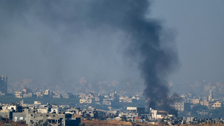 Smoke rises from damaged buildings in Gaza after a temporary truce between Israel and Hamas expired
