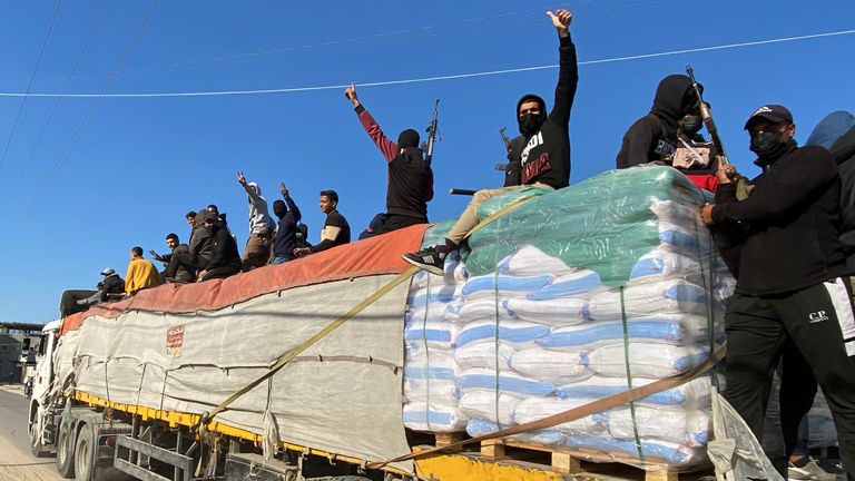Hamas fighters ride on top of a humanitarian aid truck in Rafah. Pic: AP