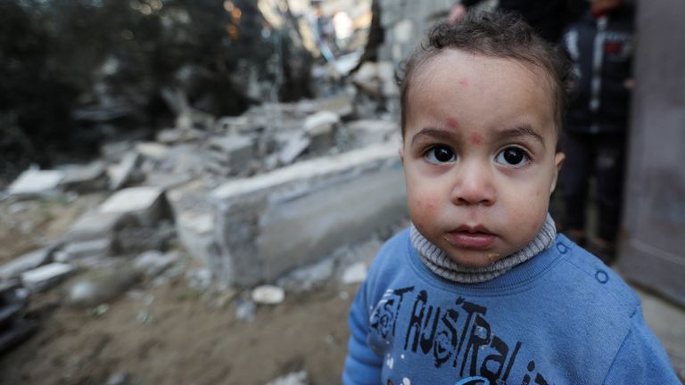 A Palestinian child looks on at the site of an Israeli strike on a house, amid the ongoing conflict between Israel and Hamas, in Rafah in the southern Gaza Strip, December 17, 2023. REUTERS/Ibraheem Abu Mustafa