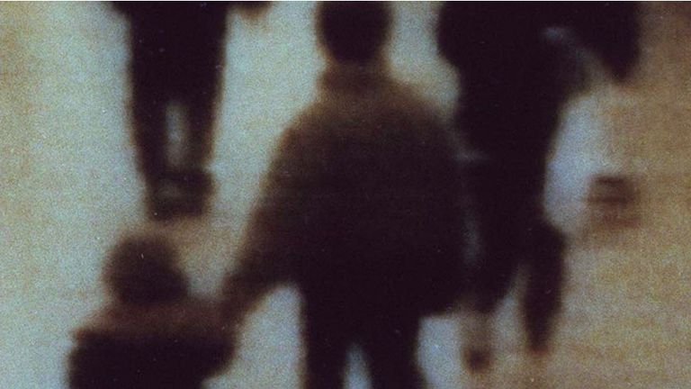 Close circuit footage shows James Bulger (L) being lead away in a shopping mall on 12 February 1993 before he was murdered
