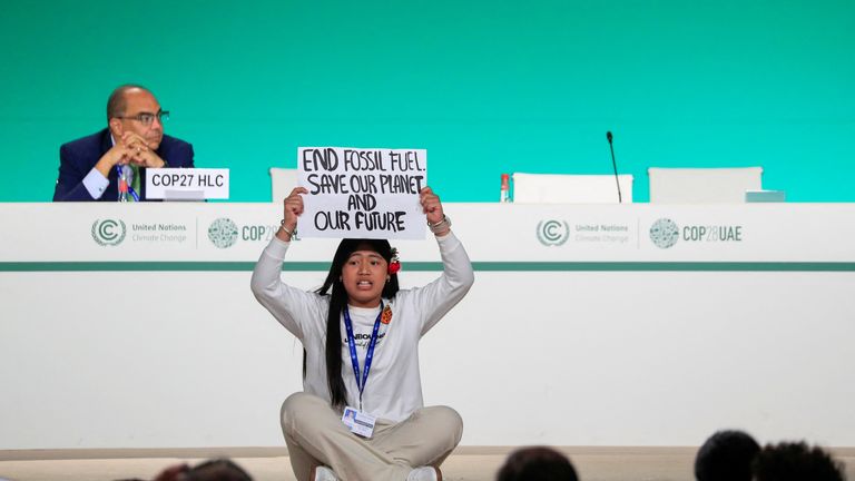 Licypriya Kangujam, an Indigenous climate activist from India, holds a banner during the United Nations Climate Change Conference (COP28) in Dubai, United Arab Emirates, December 11, 2023. REUTERS/Thomas Mukoya

