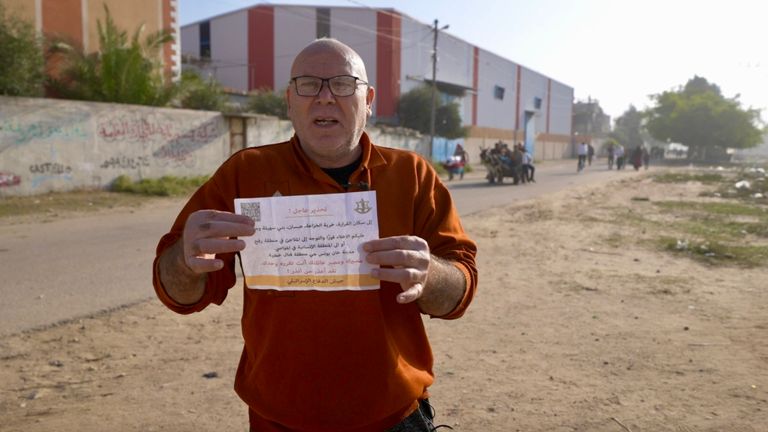 Gaza resident Mohamed Rayis seen with a leaflet  